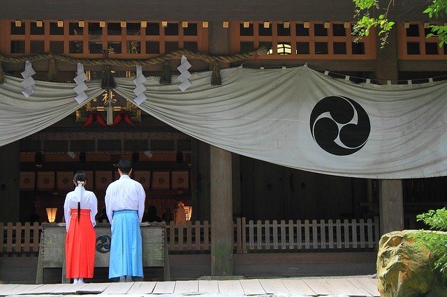 isitor performing the two bows, two claps, one bow prayer ritual at a Shinto shrine